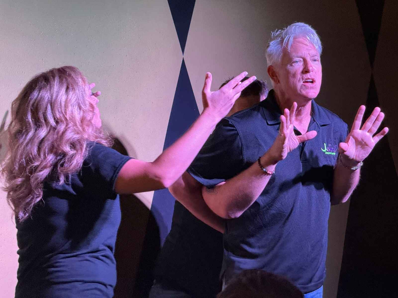 Improv comedy tickets Gilbert AZ - comedians performing an unscripted scene on stage